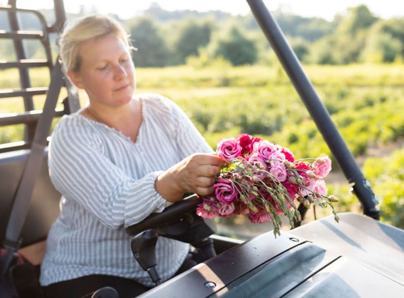 Rebecca Sadlowski gracefully holding a vibrant Lisianthus bouquet, showcasing the flower's delicate petals and varied hues.