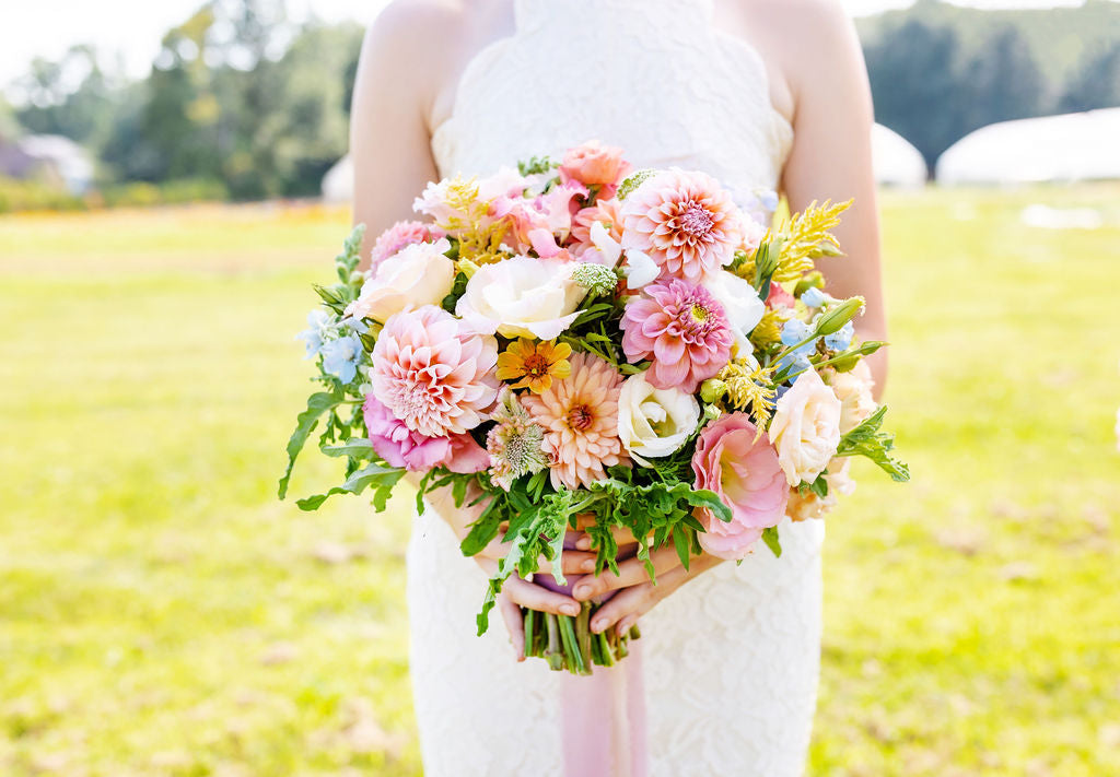 Elegant garden-style wedding bouquet featuring a mix of fresh blooms and lush greenery, perfect for a romantic outdoor ceremony.