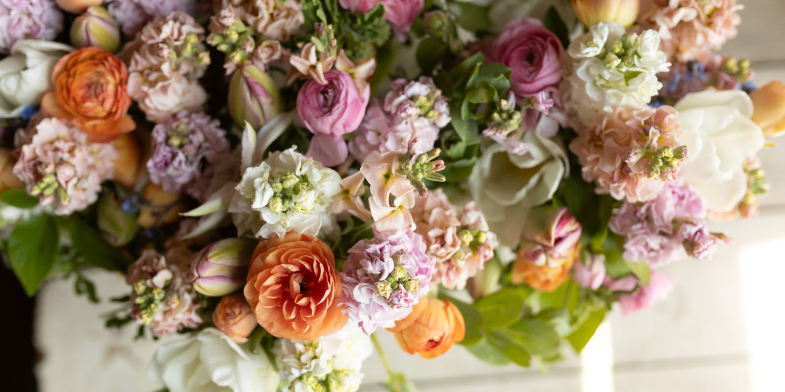 An abundant mix of pink, apricot, cream and lavender flowers.