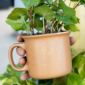 A coffee mug with a plant.