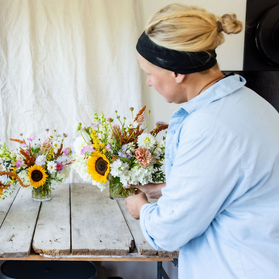 Becky arranging summer bouquets at Rooted Flowers