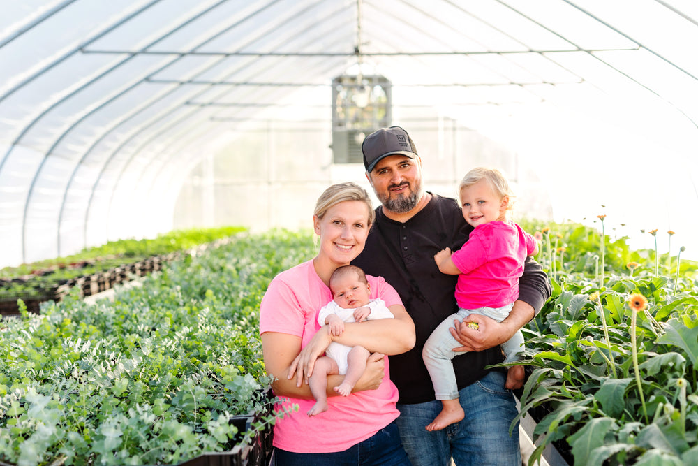 The Rooted Flowers family together in the greenhouse