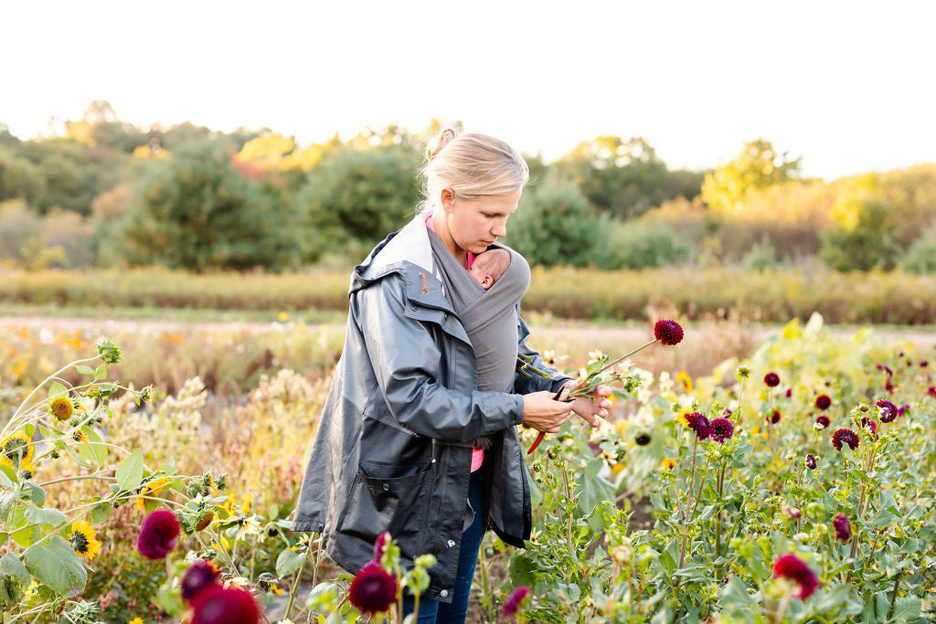 Flower picking among blooming rows at Rooted Flowers